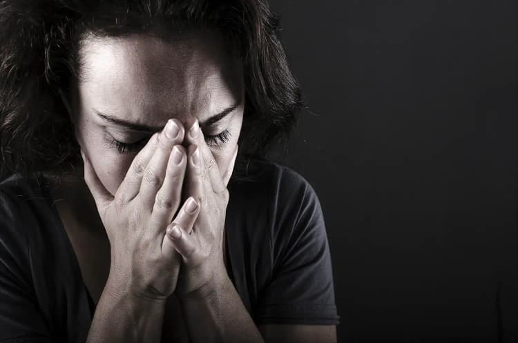 A sad woman crying because she wants to stop gambling.